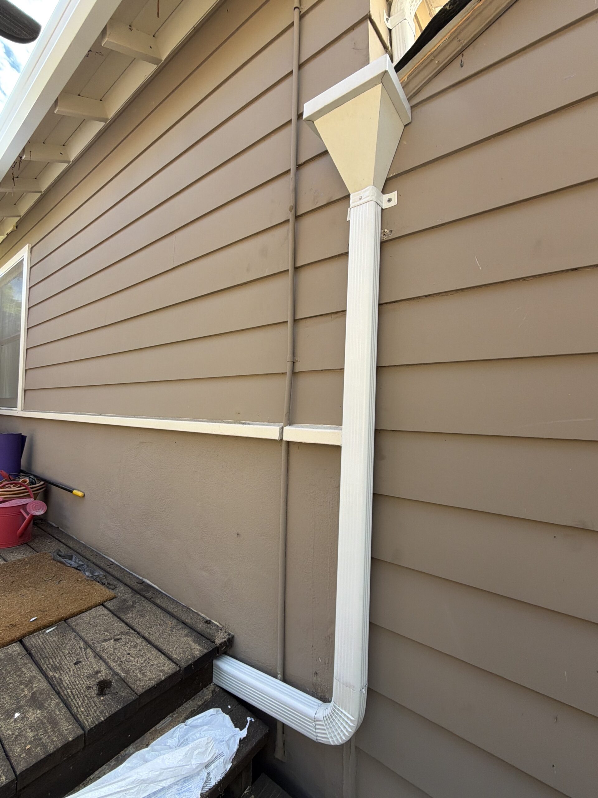 Close-up of new aluminum gutter and downspout installed by LAAC Roofing Bay Area