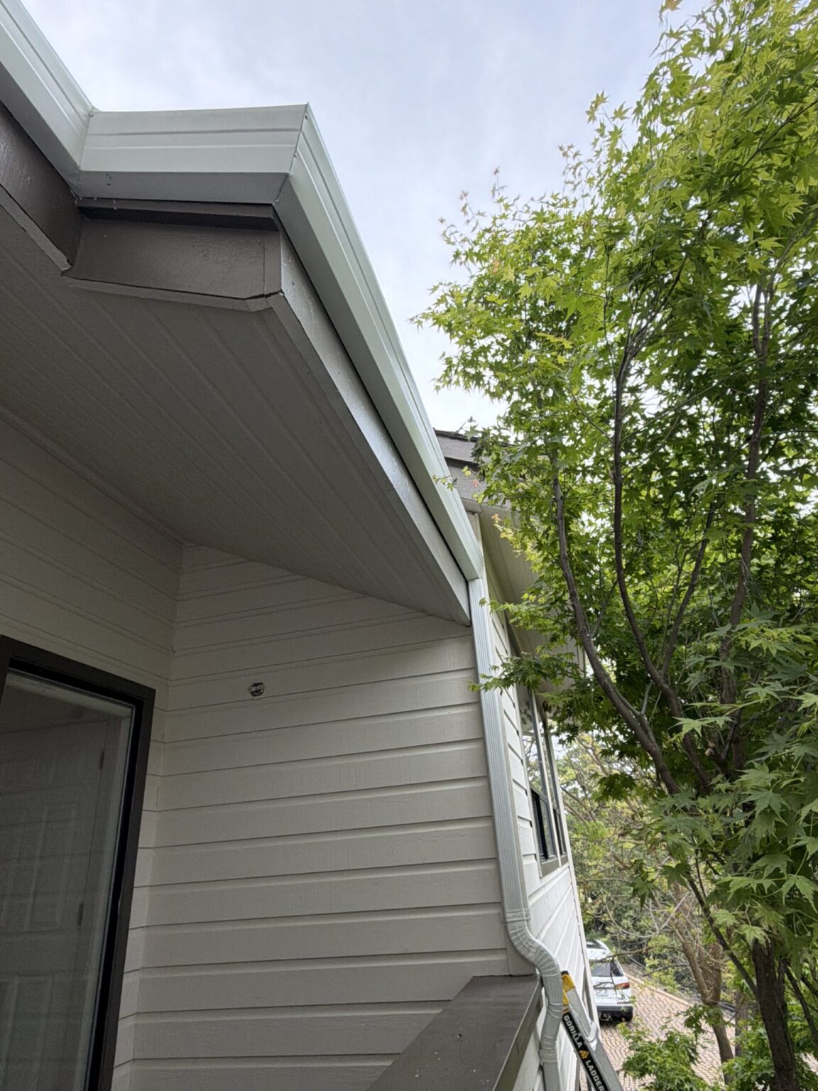 Metal roof edge with new gutter installation by LAAC Roofing Services Bay Area