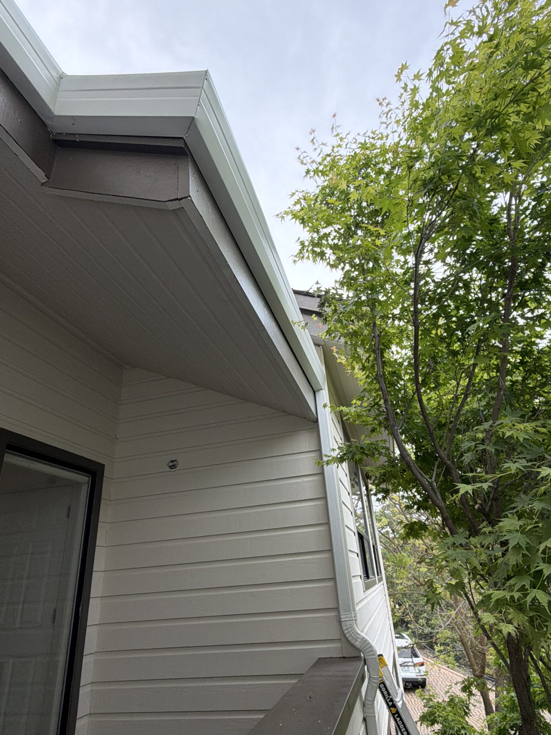 Metal roof edge with new gutter installation by LAAC Roofing Services Bay Area