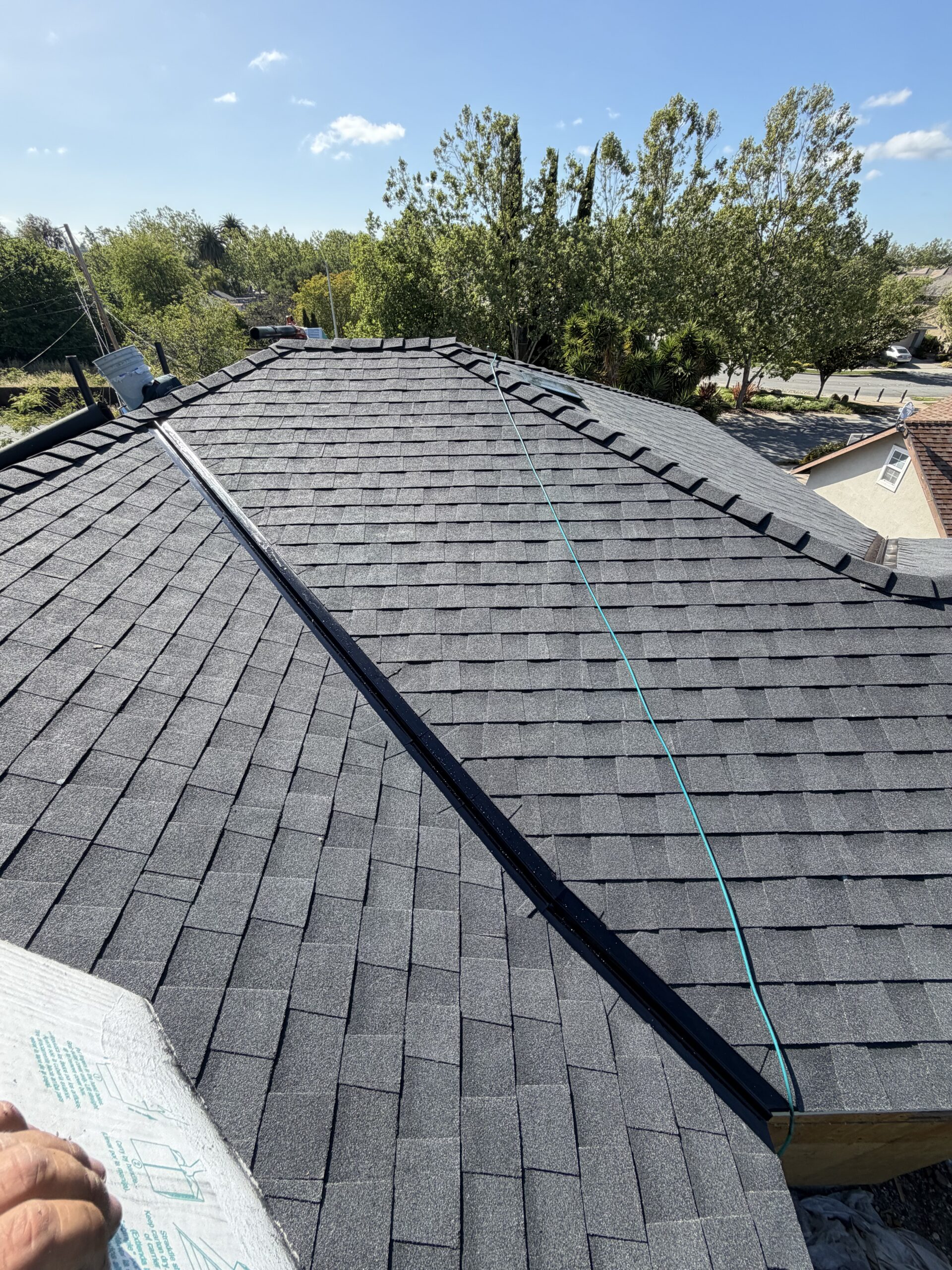 New charcoal architectural shingle installation in progress on Bay Area home by LAAC Roofing
