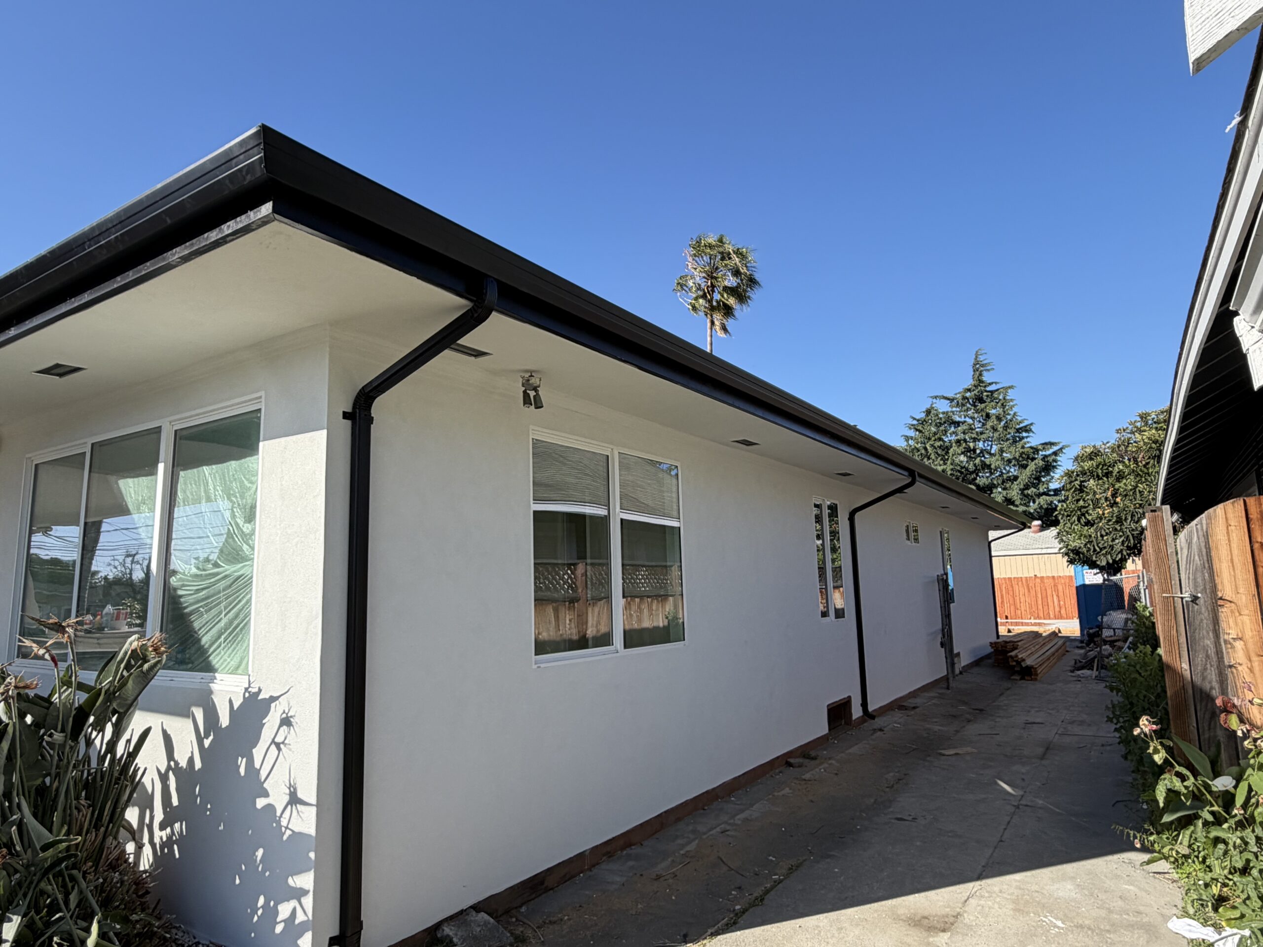 Side view of completed re-roof with new fascia and downspout on Bay Area home by LAAC Roofing
